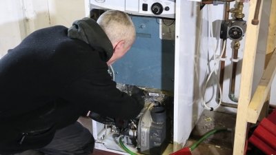 man fixing oil boiler