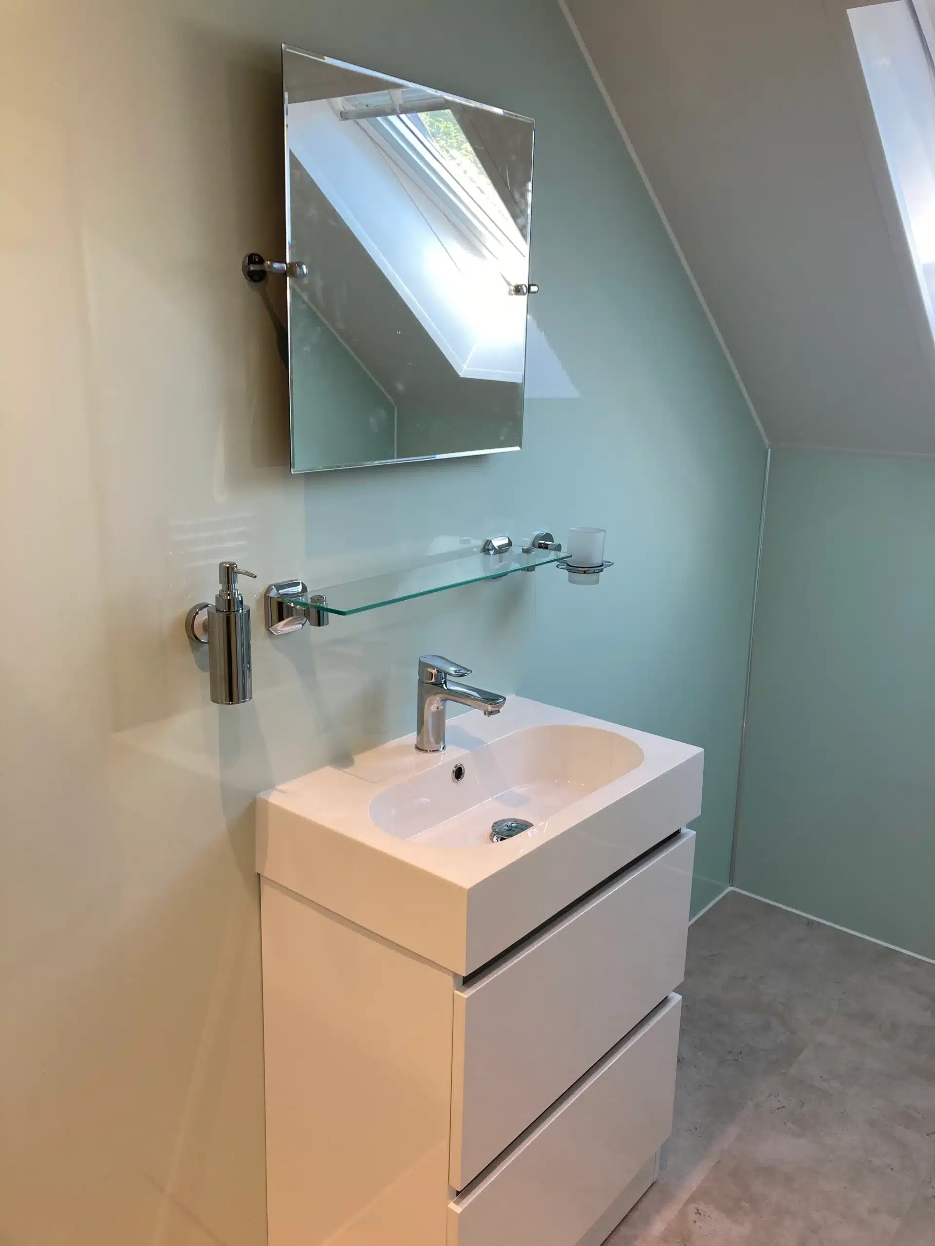 renovated bathroom sink and mirrors newly renovated wet room with white unit, white sink and glass mirror with a pale blue wall